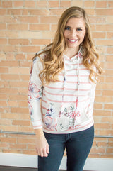 Model wearing floral sweatshirt.
