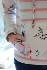 Pocket detail on floral sweatshirt.